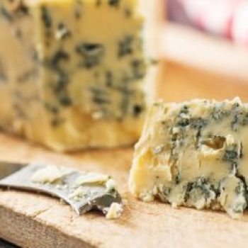 Tasty blue cheese on cutting board.